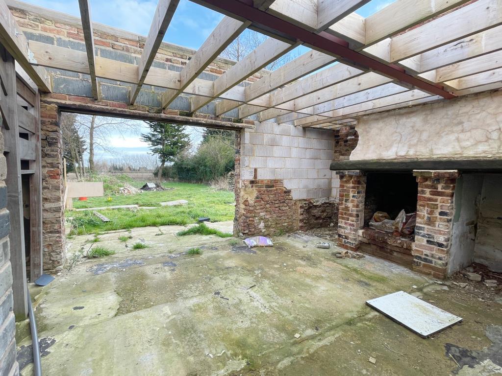 Lot: 101 - COTTAGE RENOVATION PROJECT WITH PLANNING IN VILLAGE LOCATION - Fireplace and doorway looking out to the rear garden